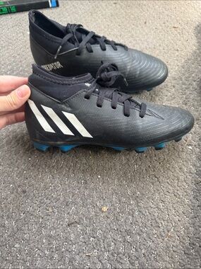 Boys adidas Black Soccer Cleats with White Stripes and Blue bottoms